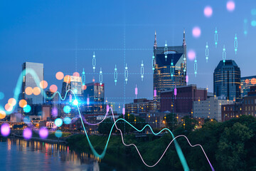 Panoramic view of Broadway district of Nashville over the river at illuminated night skyline, Tennessee, USA. Forex candlestick graph hologram. The concept of internet trading, brokerage and analysis