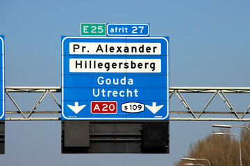 Blue direction and information sign for the directions on Motorway A16 to Den Haag and Gouda (A20)