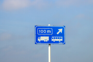 Blue information sign for the directions on Motorway A20 for special lane for trucks and buses