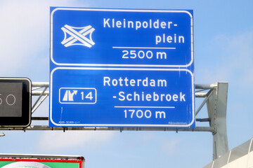 Blue direction and information sign for the directions on Motorway A20 heading crossing Kleinpolderplein and junction 14