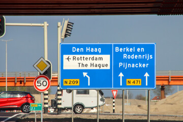 Blue direction and information sign for the directions on Motorway N471 and N209 heading Berkel, Pijnacker and The Hague