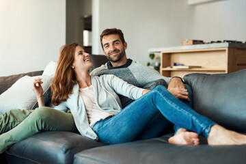 My weekend has officially kicked off. Full length shot of an affectionate young couple relaxing on their sofa at home.