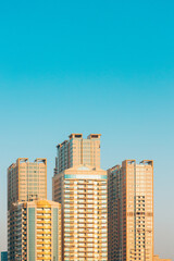 Fototapeta na wymiar New Residential Multi-storey Houses On Blue Sky. Real Estate, Development Industry. UAE.