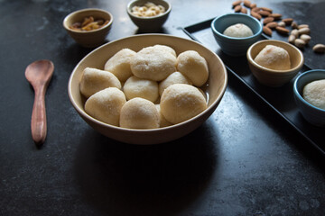 Indian dessert item rasgulla or rosogolla in a bowl. Close up, selective focus.