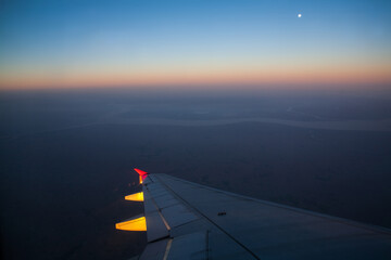 Fototapeta na wymiar Flight landing at sunset sky