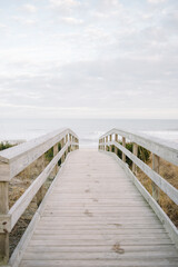 Fototapeta na wymiar Boardwalk to Carolina Beach with wet footprints