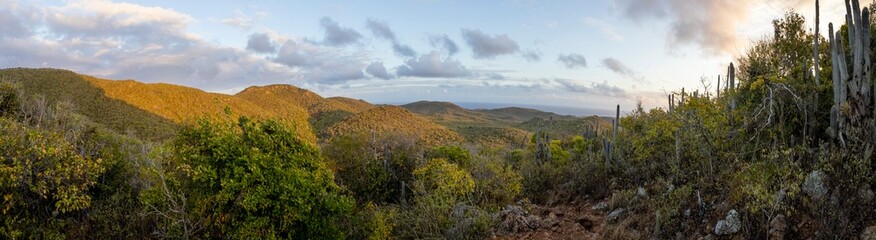 Sunrise over Christoffel National Park during the hike up to the top of Christoffel mountain on the Caribbean island Curacao - panorama - obrazy, fototapety, plakaty