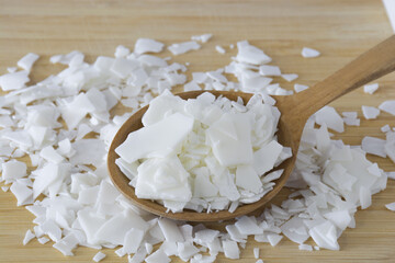 Close up of white soy wax flakes for candle making. Light texture of soy wax flakes. Ingredient for...