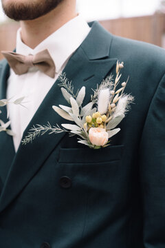 Boutonniere of the groom in a suit