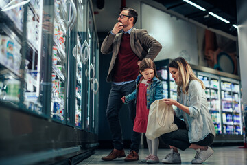 Family shopping in modern supermarket
