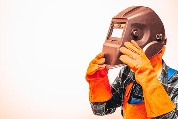 Heavy industry worker in a protective suit with a mask to protect the eyes and face, fiery colors,...