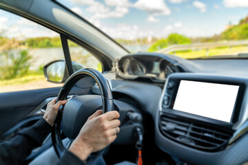Female hands on the steering wheel in the car, control screen isolated. Navigation for traveling by...