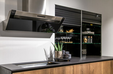 Part of a modern kitchen, a place for cooking, extractor and stove.