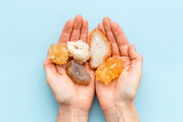 Natural crystal mineral stone in hands. Crystal texture closeup