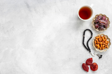 Islamic rosary with dates and tea. Ramadan Kareem concept.