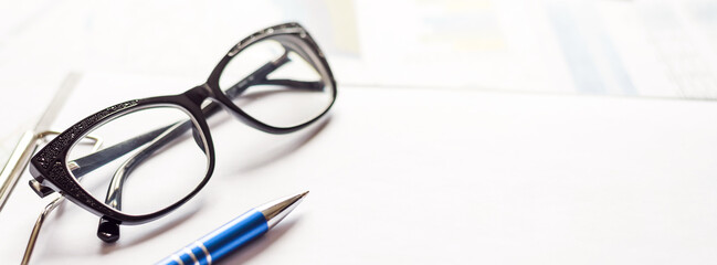 Pen, Glasses, and clipboard Paper close up. Business concept
