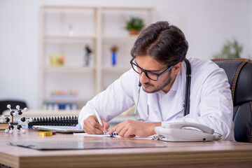 Young male doctor working in the clinic