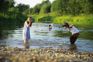 Fototapeta premium Children walk in the summer in nature. Child on a sunny spring morning in the park. Traveling with children.