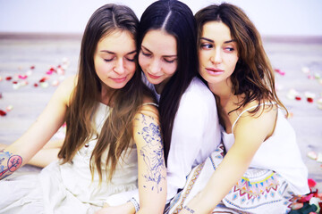 Obraz premium Women's Recovery Group. Yoga girl. Diverse Girls Smiling Holding Hands Sitting In Circle Indoor. Selective Focus.
