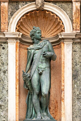Fototapeta na wymiar Apollo nude bronze statue in Venice on Loggetta del Sansovino 