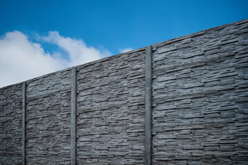 Fence of Pyrenean stone panels. Artificial concrete panels imitating natural stone.