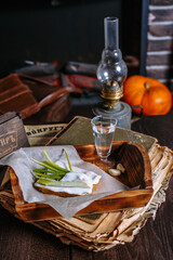 A sandwich of black bread and lard, lying on a tray of the tavern. Garlic, dill, a shot of vodka. Traditional Ukrainian snack