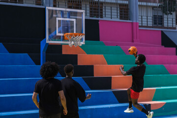 Man with afro hair trying to make a basket playing basketball