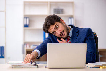 Young male employee working in the office