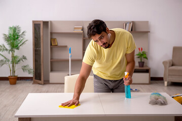 Young man doing housework at home