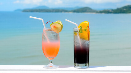 Fresh cold iced cocktail on tropical beach with blue sea at hot sunny day. Summer sea vacation and travel concept