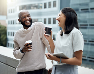 Business talk mixed with a little chit-chat. Shot of two businesspeople drinking coffee together outside an office.