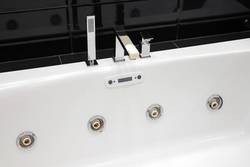 Faucet and jacuzzi tub in modern bathroom