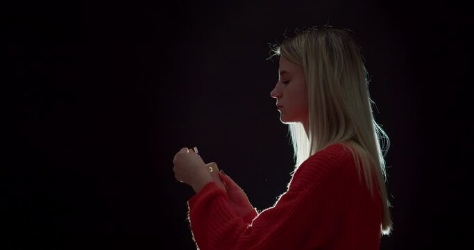 Young woman with vape mod on black background