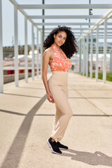 Obraz premium Enjoyment - free happy american african woman with afro enjoying sunset. Beautiful woman in white dress in the city