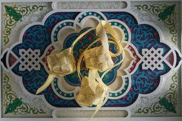 gold color ribbon ketupat on arabic design element food tray