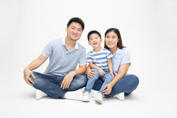 Fototapeta na wymiar Asian family smiling and sitting together on floor isolated white background. Young thai family concept