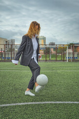 woman soccer player with ball on the field. ball dribbling, feint.