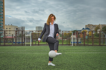 woman soccer player with ball on the field. ball dribbling, feint. © Olek