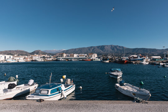 boats moored at the marina with calm sea and blue sky in motril, Andalucia Spain.