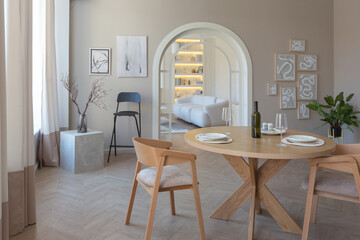fashionable modern design luxury apartment in light colors. bright day behind huge windows. stylish decoration and no one inside.