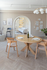 fashionable modern design luxury apartment in light colors. bright day behind huge windows. stylish decoration and no one inside.