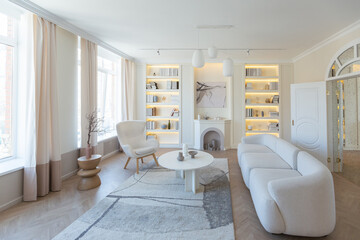 fashionable modern design luxury apartment in light colors. bright day behind huge windows. stylish decoration and no one inside.