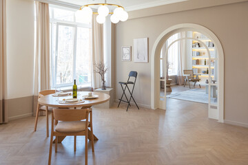 fashionable modern design luxury apartment in light colors. bright day behind huge windows. stylish decoration and no one inside.