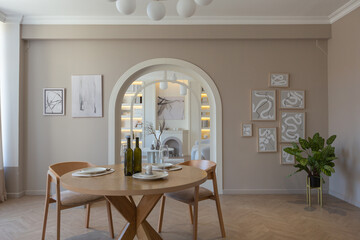 fashionable modern design luxury apartment in light colors. bright day behind huge windows. stylish decoration and no one inside.