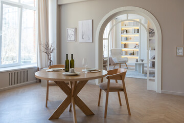 fashionable modern design luxury apartment in light colors. bright day behind huge windows. stylish decoration and no one inside.
