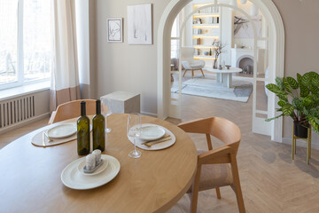 fashionable modern design luxury apartment in light colors. bright day behind huge windows. stylish decoration and no one inside.