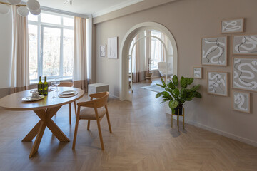 fashionable modern design luxury apartment in light colors. bright day behind huge windows. stylish decoration and no one inside.
