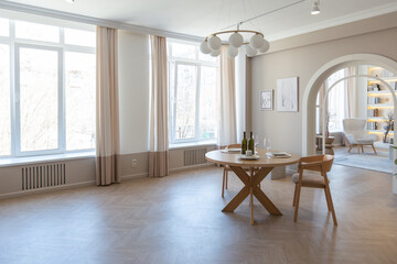 fashionable modern design luxury apartment in light colors. bright day behind huge windows. stylish decoration and no one inside.