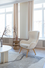 fashionable modern design luxury apartment in light colors. bright day behind huge windows. stylish decoration and no one inside.