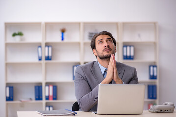 Young male employee working in the office